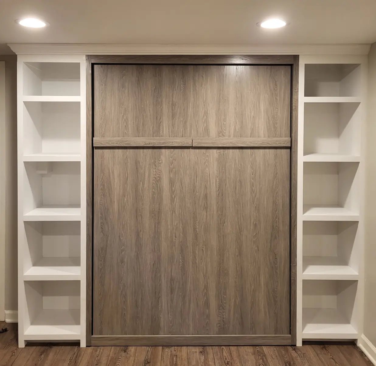 Custom floor-to-ceiling built-in bookshelves flanking a fireplace in a Clintonville living room