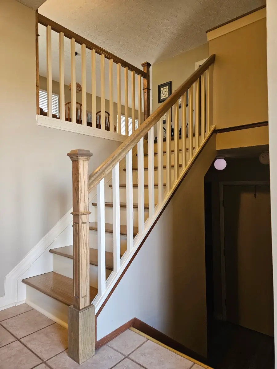 Rebuilt oak staircase railing with solid newel post and balusters in a Clintonville home